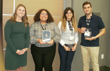 Group representatives receiving the award, including Emani Brinkman, Farnaz Fatahi, and Sepehr Yadollahi.