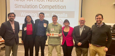 Group picture of the winning team and judges for the 2024 NASPPA Simulation Competition, with student Josh Squires in the center.